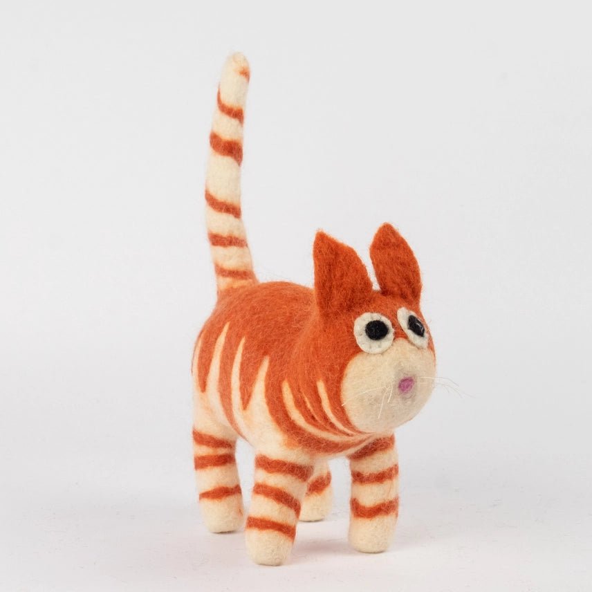 A felt needle art cat figurine in orange and cream stripes, standing on a light gray background.