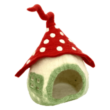 Green and cream-colored felt mushroom house with a red polka-dot roof on a white background