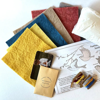 Bird sewing kit with felt, thread, and instructions on a white background