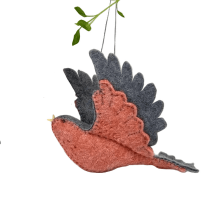 Red and grey felt bird ornament hanging from a branch on a white background