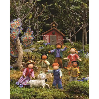 Miniature scene with children and a red cabin in a forest setting