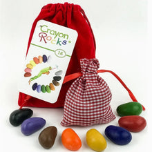 Crayon Rocks toy set with 16 colored crayon-shaped rocks, a red drawstring bag, and a red-and-white gingham pouch with 8 more crayons on a white background.