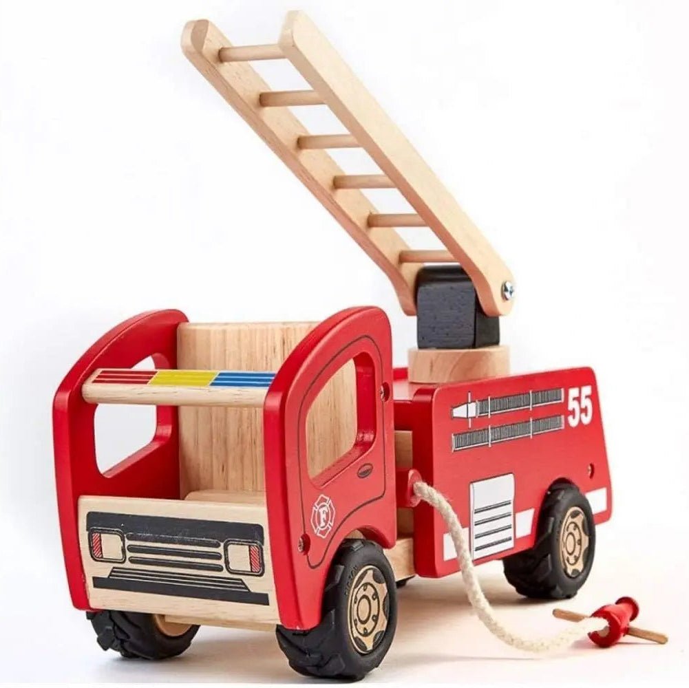 A wooden toy fire truck with a red-painted body and natural wood interior, ladder, wheels, and front grille. It has black wheels with gold-toned centers, white '55' markings, a small fire emblem, and a white rope with a red-and-tan pull toy attached.
