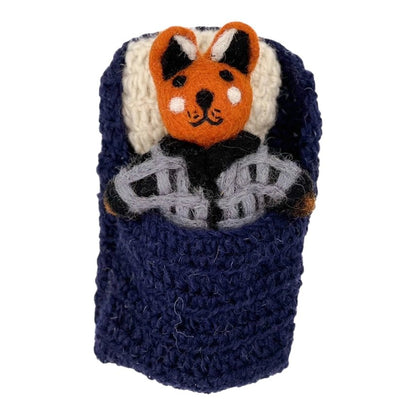 Felted fox doll in a knitted sleeping bag on a white background