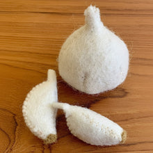 Felted garlic 3 pc. on a wood surface