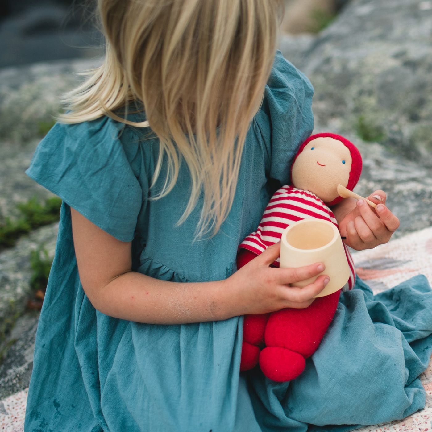 Girl feeding organic cotton doll from Keptin-Jr