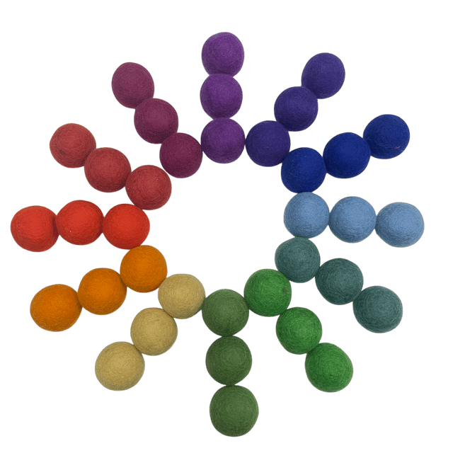 36 felt balls in 12 idfferent colors arranged in a circle on a white background