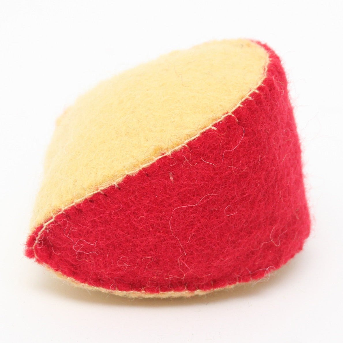 Side view of wedge of felted gouda cheese on a white background