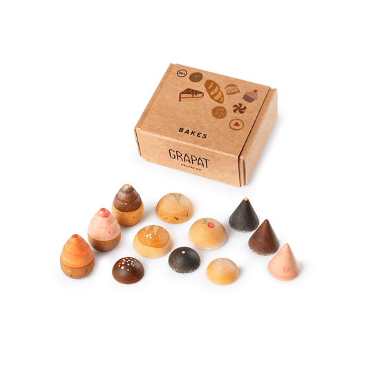 Box of assorted small wooden pastries with a visible brand logo on a white background