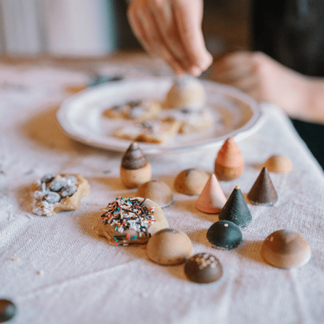 Small wooden pastries on a table with real cookies