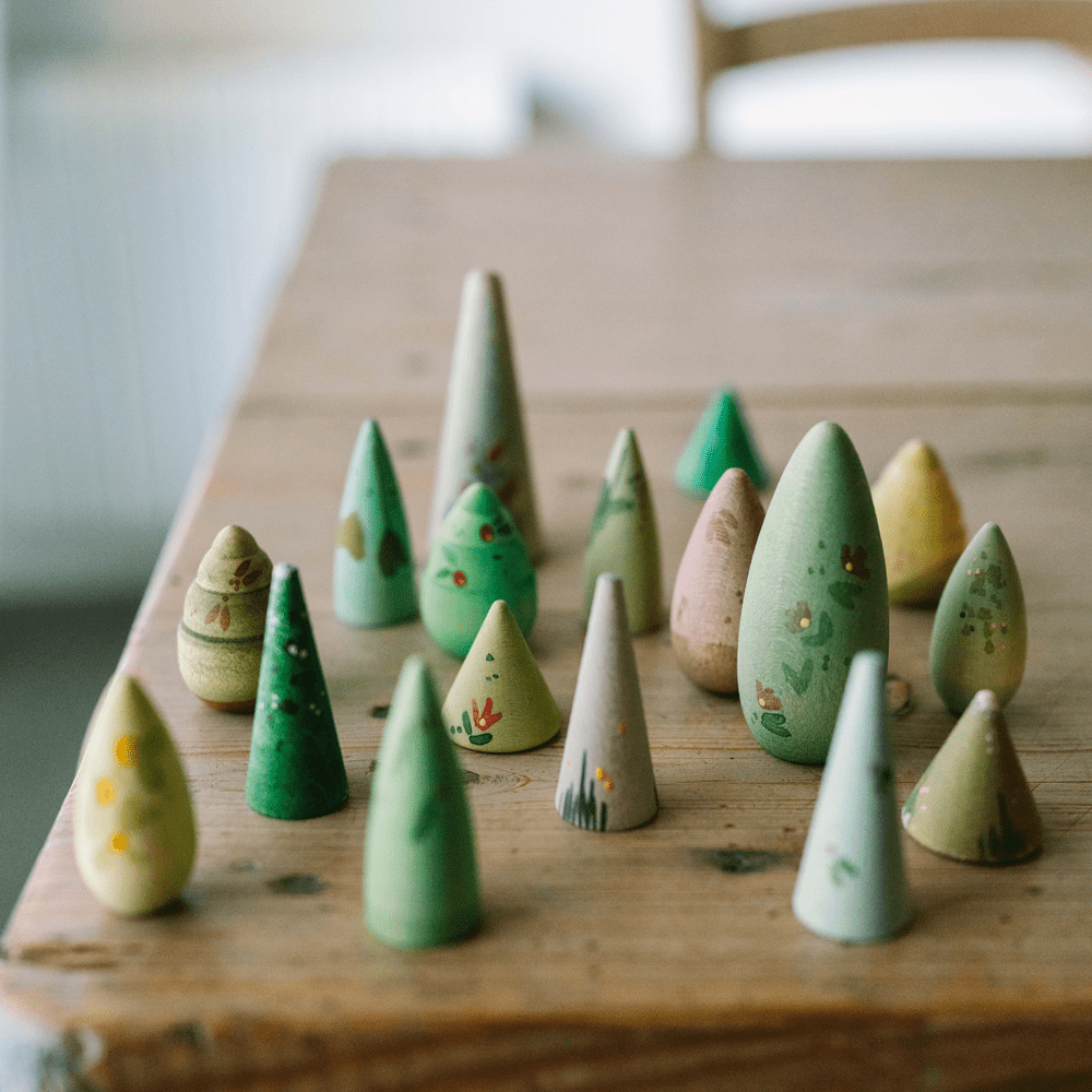 Arrangement of wooden trees of various sizeson a wooden table