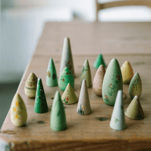 Arrangement of wooden trees of various sizeson a wooden table