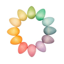 Pastel-colored Easter eggs arranged in a circular pattern on a white background