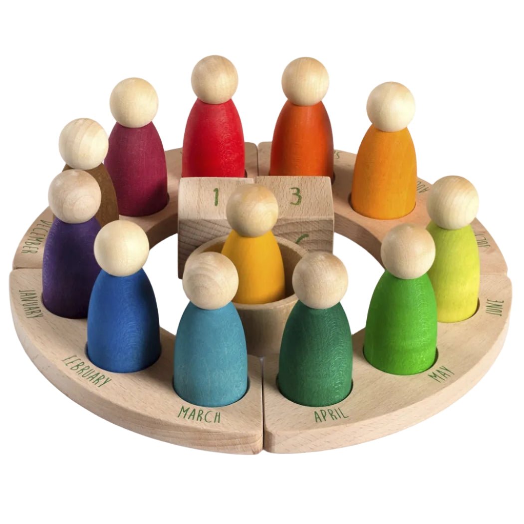 12 wooden peg people in different colors in a wooden base with the months of the year on a white background