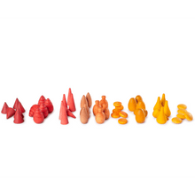 Colorful wooden toy shapes arranged in a row on a white background