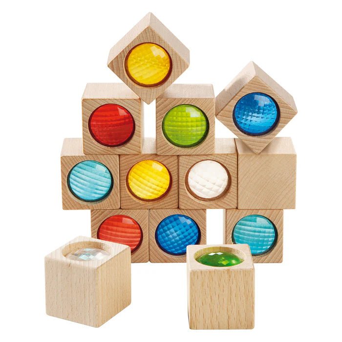 Wooden blocks with colored kaleidoscope inserts on a white background