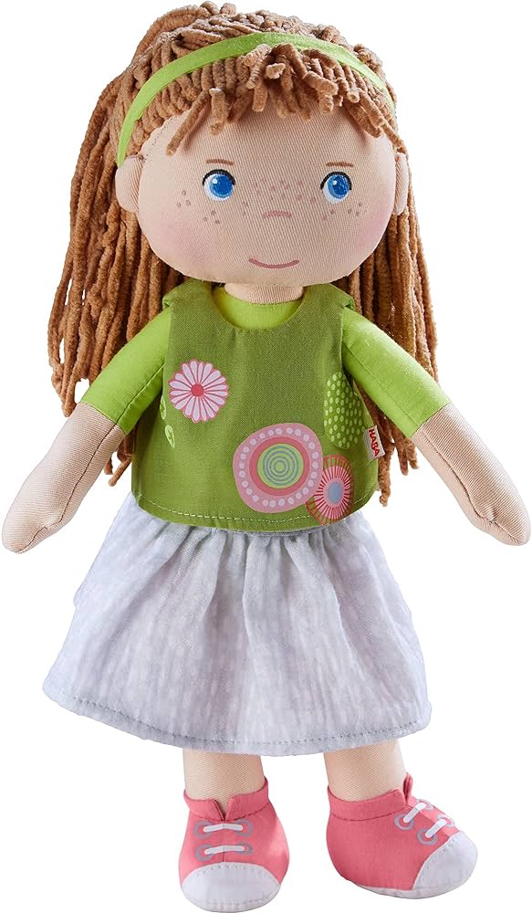Doll with green top and gray skirt on a white background