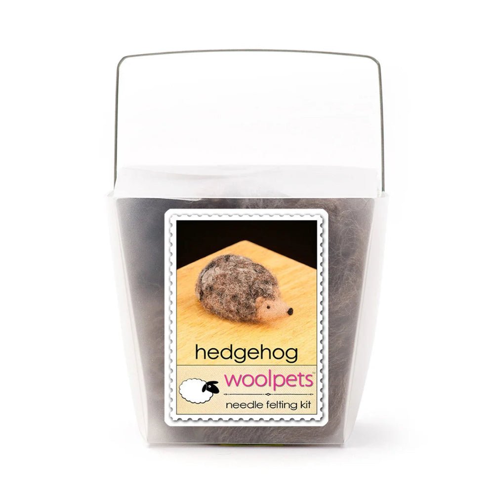 Frosted plastic container with materials to make a felted hedgehog with woolpets branding on a white background