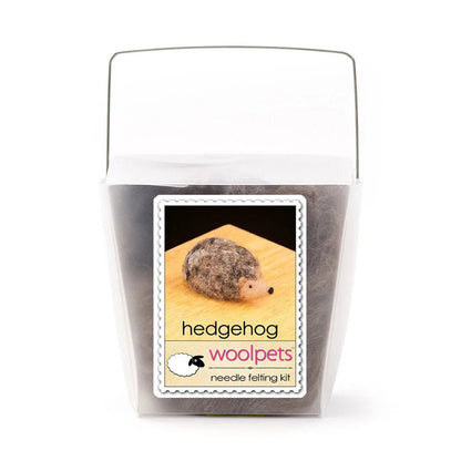 Frosted plastic container with materials to make a felted hedgehog with woolpets branding on a white background