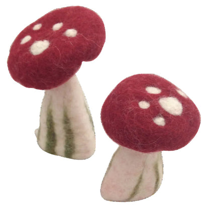 2 felted red and white mushrooms on a white background