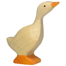 Wooden toy goose standing against a white background