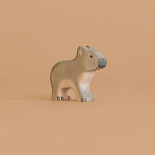 Wooden koala toy figure on a light colored background