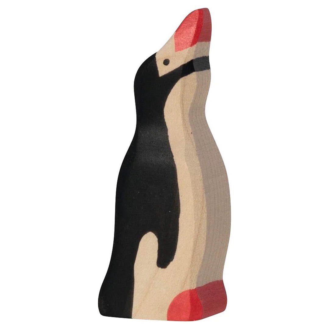Wooden penguin toy with black body, beige back, and red feet on a white background