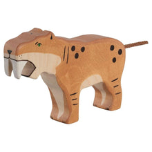Wooden toy saber-toothed tiger figure on a white background