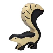 Wooden skunk figure on a white background