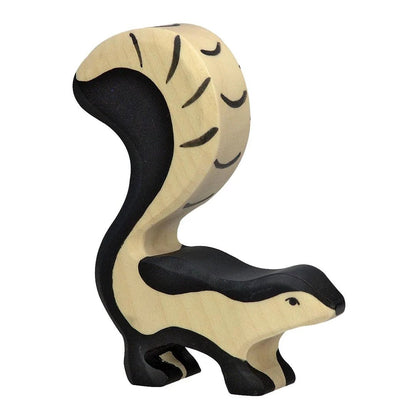 Wooden animal figure of a skunk on a white background