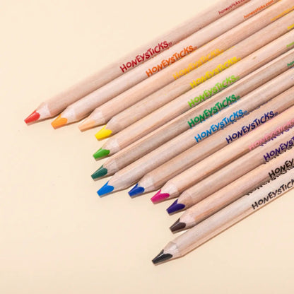 Colorful pencils with 'Honeysticks' branding on a beige background