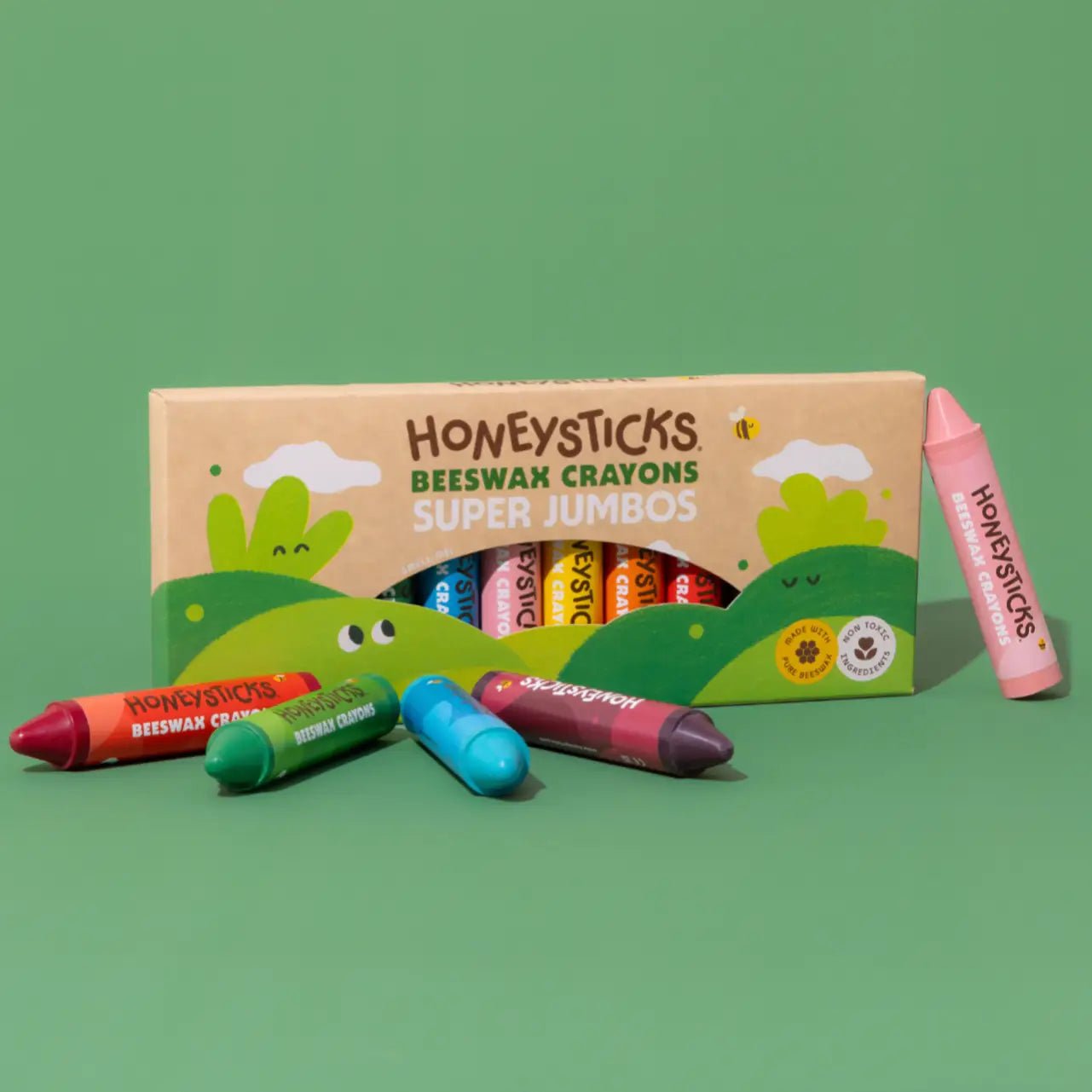 Box of Honeysticks Super Jumbo crayons on a green background