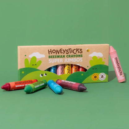 Box of Honeysticks Super Jumbo crayons on a green background