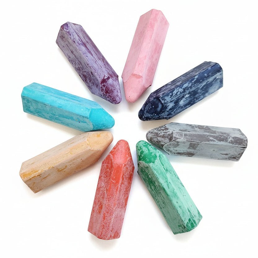 Assorted triangle-shaped crayons arranged in a circle on a white background