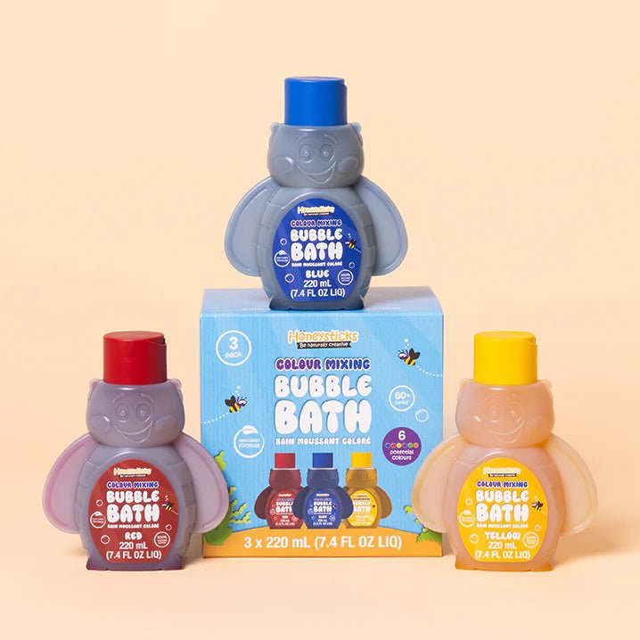 Honeysticks bubble bath bottles in red, blue, and yellow on a beige background