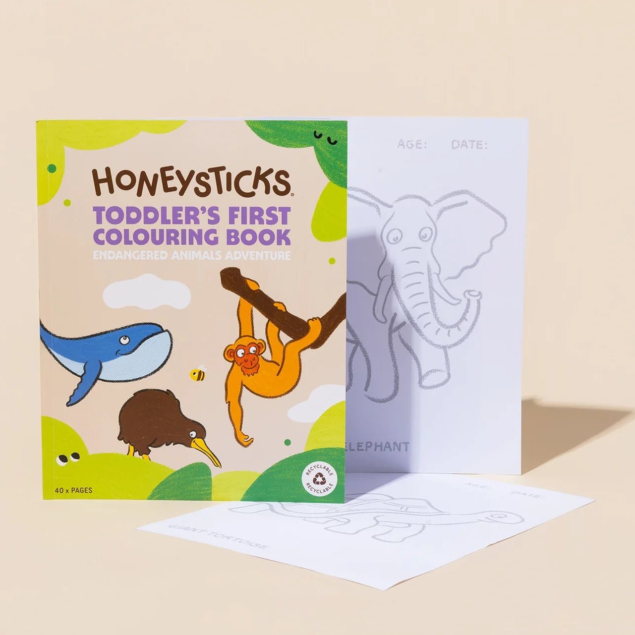 Toddler's first colouring book by Honeysticks, featuring a colorful cover with cartoon animals and two white coloring pages in front, set against a warm beige background.