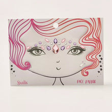 Snails brand face tattoo with pink, purple, and clear gems