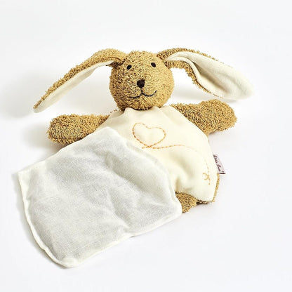 A plush bunny lovey comforter featuring a brown textured bunny head and ears with a cream-colored soft blanket draped over it, decorated with a small embroidered heart.
