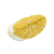 Yellow felt lemon wedge on a white background