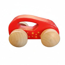 A small wooden toy car with a red painted body, yellow star details, and natural light wood wheels on a white background