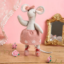 Felted mouse in a pink dress with flowers and a mirror in the background