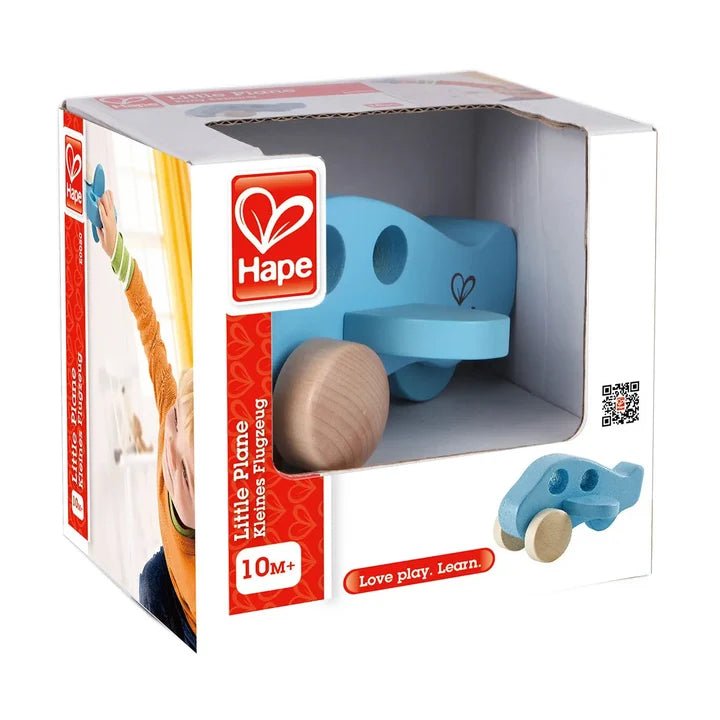 Hape Little Plane wooden toy in its original retail packaging, showing the blue airplane and wooden wheels through a clear window on a white background.