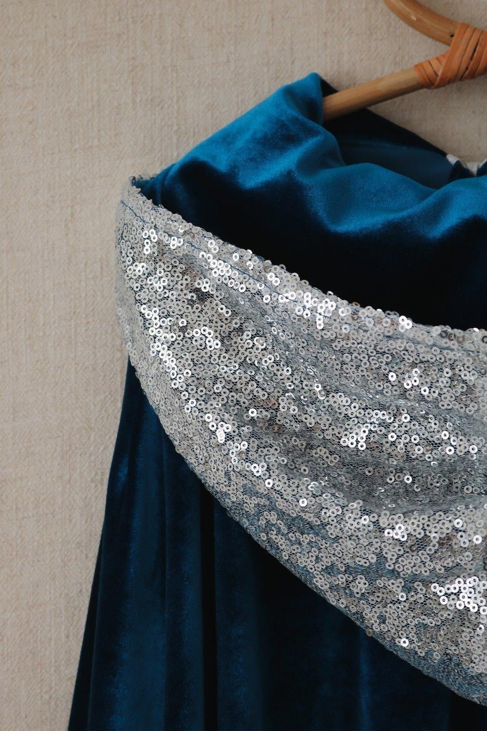 Close-up of the silver sequined hood edge layered over the deep blue velvet Snow Queen cape