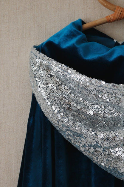 Close-up of the silver sequined hood edge layered over the deep blue velvet Snow Queen cape
