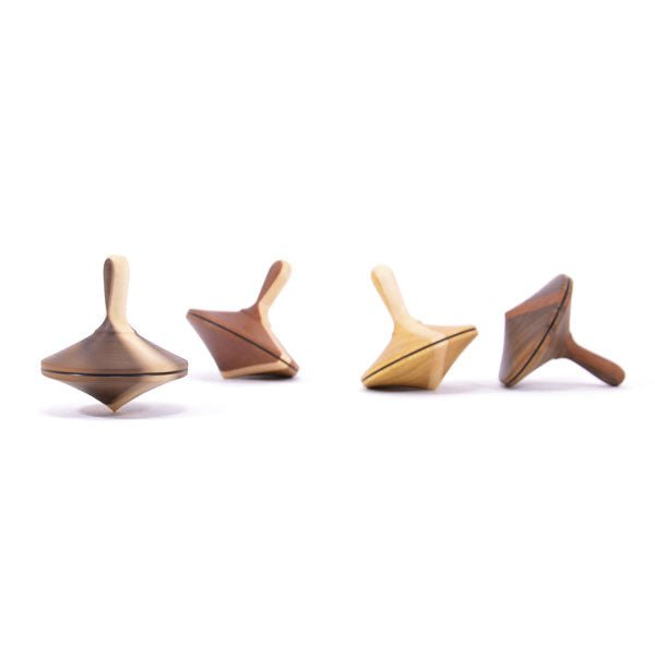 Four wooden tops made of different types of wood on a white background