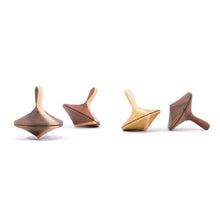 Four wooden tops made of different types of wood on a white background
