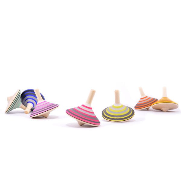 Colorful wooden spinning tops on a white background
