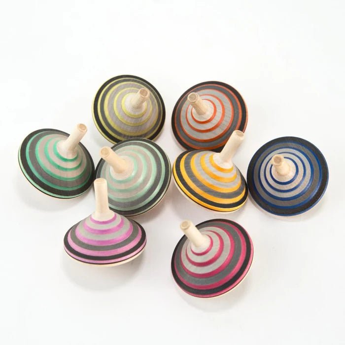 Set of colorful wooden spinning tops on a white background