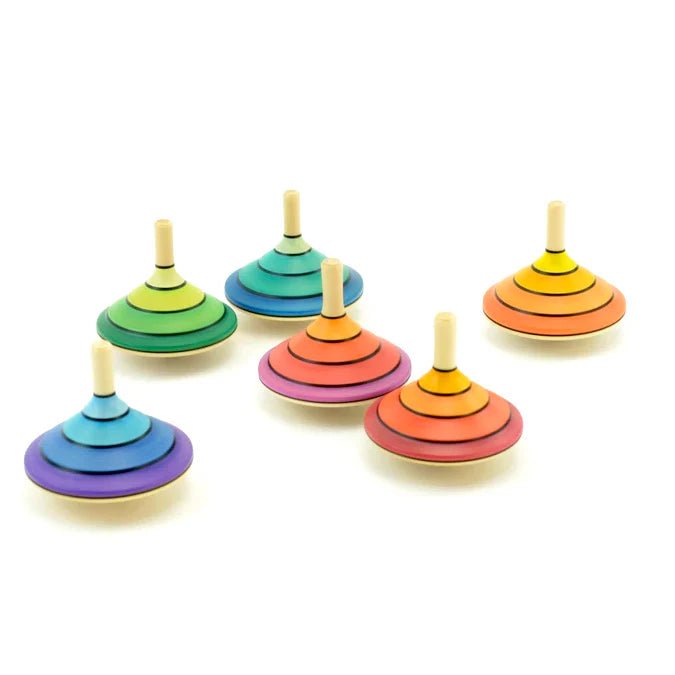 Set of colorful wooden spinning tops on a white background