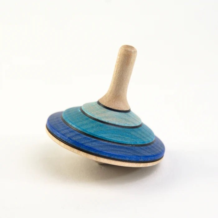 Wooden spinning top with blue and green striped disc on a white background